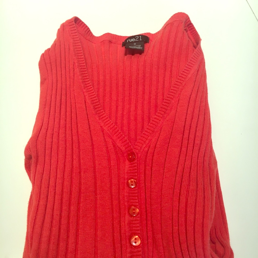 Orange sweater with decorative buttons